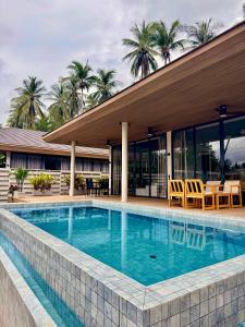 a swimming pool in front of a building at Siam Residence - Modern Villa with a Private Pool in Koh Phangan