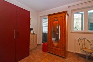 a room with a wooden cabinet with a mirror at Apartments Kada 1571 in Pula +38 photos