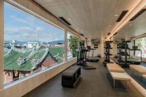 a gym with a view of the city from the window at Citadines Connect Bertam Georgetown Penang in George Town