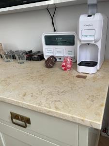a kitchen counter with a printer and a toaster at Apartmány Naxarův dvůr in Horažďovice