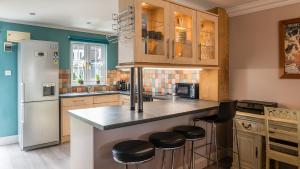 a kitchen with a counter and a refrigerator at Venture Lakeside Lodge in South Cerney