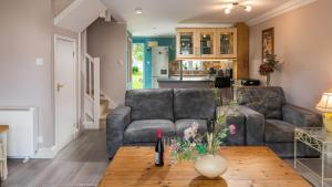 a living room with a couch and a table at Venture Lakeside Lodge in South Cerney +16 photos