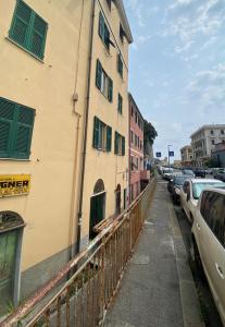a street with cars parked next to a building at Appartamento a due passi dal mare in Genova +6 photos