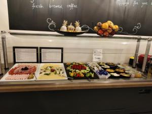 a display case with many different types of food at Arthotel ANA Gala in Vienna +18 photos
