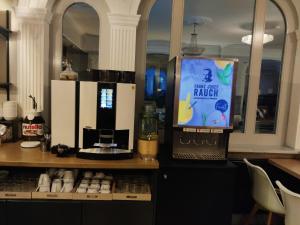 a counter with a coffee maker and a laptop on it at Arthotel ANA Gala in Vienna