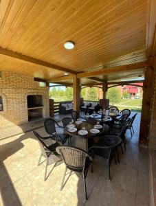 a group of tables and chairs on a patio at Jansaya Resort база отдыха Жансая in Aleksandrovka