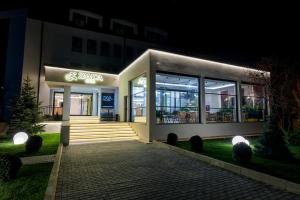 a store front at night with lights at Hotel Zamca Suceava in Suceava