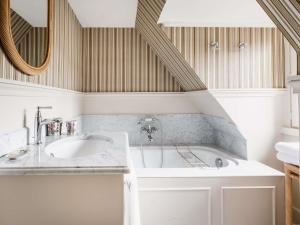 a bathroom with a sink and a tub at Abbaye Des Vaux De Cernay in Cernay-la-Ville +87 photos
