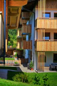 a building with wooden balconies on the side of it at Aparthotel Iris - inklusive Wildschönau Premium Card in Auffach +63 photos