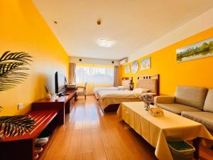 a hotel room with yellow walls and a living room at New Jinshan Apartment in Beijing