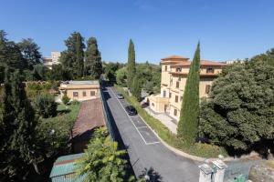 a view of a house and a street with a train at San Luigi - Residenza Gemelli in Rome