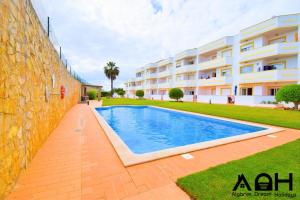 a swimming pool in front of a building at Luz do Sol in Guia
