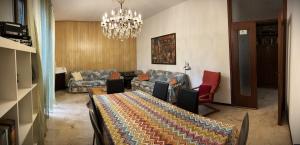 a living room with a table and chairs and a chandelier at Paolo&SilviaHost in Seriate +15 photos