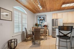 a kitchen and dining room with a table and chairs at Charter Landing A7 in Orange Beach