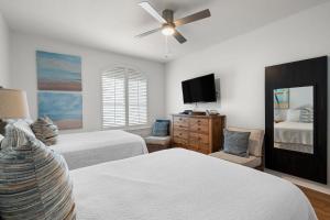 a bedroom with two beds and a flat screen tv at Charter Landing A7 in Orange Beach +26 photos
