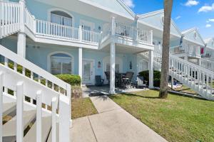 a large white house with white railings at Charter Landing A7 in Orange Beach