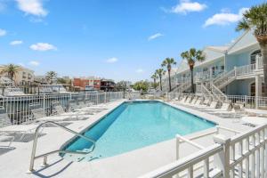 a swimming pool with lounge chairs and a resort at Charter Landing A7 in Orange Beach