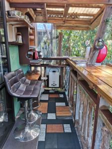 a room with a bar stool in a tiny house at The Abel Tasman Treehouse in Marahau