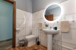a bathroom with a toilet and a sink and a mirror at Casa Vale Sereno in Boaventura in Cabo da Ribeira +14 photos