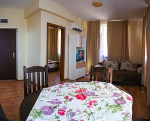 a living room with a table with a flower pattern on it at Villa Maria in Tsarevo