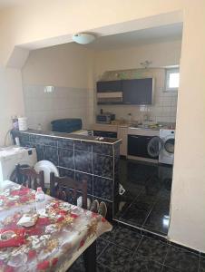 cocina con mesa y cocina con lavadora en стаи за настаняване, en Razgrad