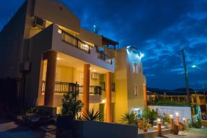 a villa with a lit up facade at night at Vrokastro Apartments in Istro