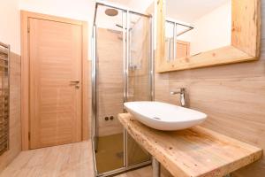 a bathroom with a sink and a shower at Albergo Locanda Mezzosoldo in Mortaso +22 photos
