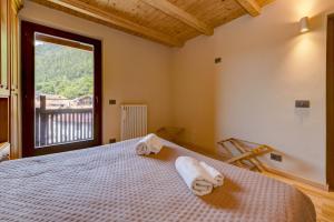 a bedroom with a bed with towels on it at Albergo Locanda Mezzosoldo in Mortaso