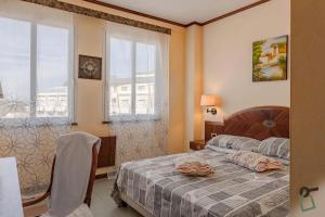 a bedroom with a bed and a window at Hotiday Cecina Mare in Cecina