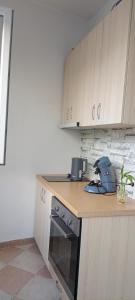 a kitchen with a counter top with a stove at Cozy Apartment, Free Parking near Dajti Cable Car, Bunk'Art in Tirana +28 photos