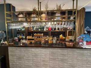 a bar in a restaurant with a lot of alcohol at Heeton Concept Aparthotel Edinburgh Queen Street in Edinburgh