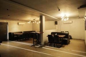 a dining room with tables and chairs and lights at Serene Stays in Chennai