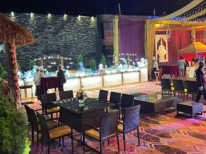 a stage with tables and chairs and a bar at The Stella Hotel & Resort in Ludhiana