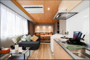 a kitchen with a couch and a living room with a bed at Sunlight Room3-2 in Tokyo