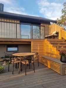 a house with a table and chairs on a deck at House by the fjord in Vadsø +35 photos