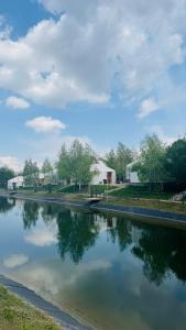 a body of water with buildings in the background at Aul Resort in Kaskelen