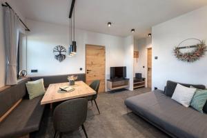 a living room with a couch and a table and a bed at Niederhof - Urlaub auf dem Bauernhof in Brixen