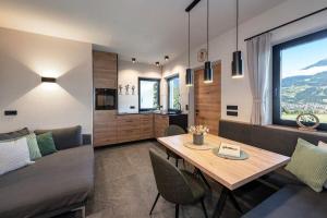 a living room with a table and a couch at Niederhof - Urlaub auf dem Bauernhof in Brixen