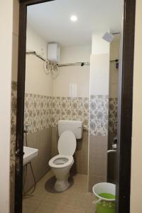 a bathroom with a toilet and a sink at Serene Stays in Chennai