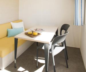 a table and chairs with a plate of food on it at Amelia Camping in Amélie-les-Bains-Palalda +12 photos