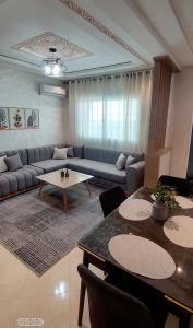 a living room with a couch and a table at Modern Apartment with Balcony in Kenitra