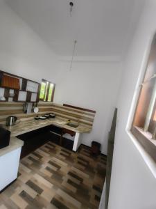 a kitchen with a wooden table and a wooden floor at Galle Serenity Bliss Private Villa in Galle