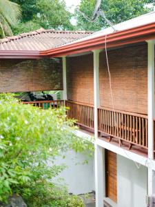 a balcony of a house with a wooden deck at Galle Serenity Bliss Private Villa in Galle