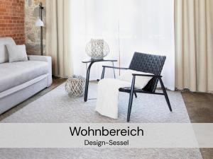 a living room with a couch and a chair at HexenburgbeiDresden Stylishes Designerappartement mit Schlafsofa, Terrasse - Nähe Sächsische Schweiz Dresden in Großharthau +26 photos
