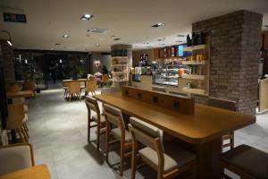 a restaurant with a large wooden table and chairs at Kent Room Hotel in Kapaklı