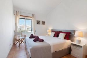 Un dormitorio con una cama grande y una ventana. en Clos des Lyces, en Santa Luzia 17 fotos más