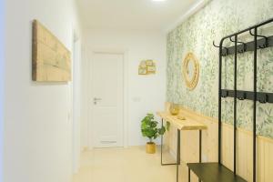 a room with a hallway with a door and a table at Medano My Place in El Médano