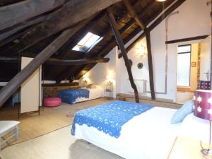 a bedroom with two beds in a attic at Casa Luna de La Viliella in La Viliella