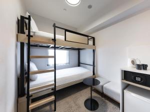 a small room with bunk beds in it at Brackets Hotel Osaka Hommachi in Osaka