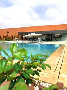 a large swimming pool in front of a building at Dar Fatma in Sidi Bibi